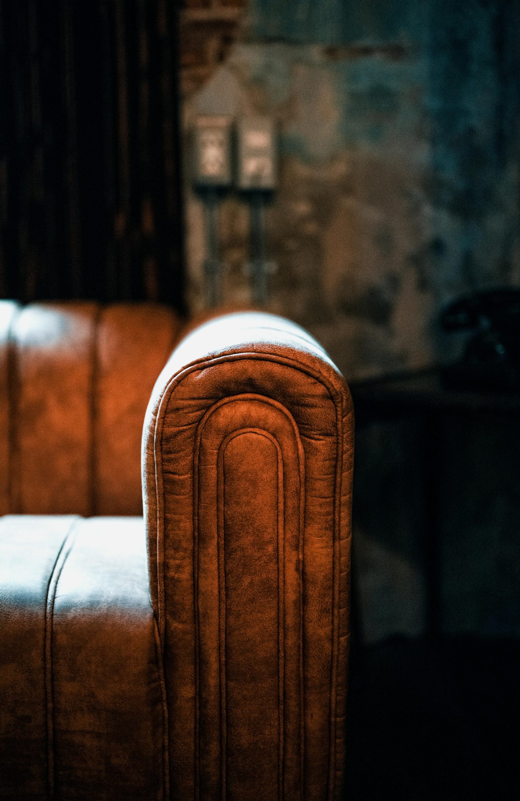 Canapé Chesterfield en cuir marron desséché montrant des craquelures de surface par manque de nutrition